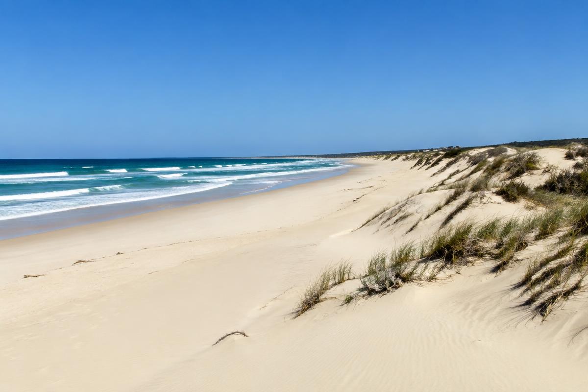 Long empty beach and dunes at Jeffreys Bay