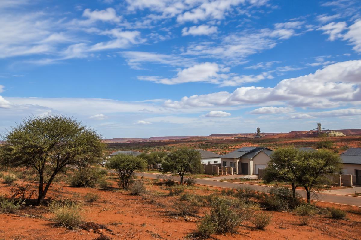 Kathu homes among camel thorn trees on red Kalahari sand