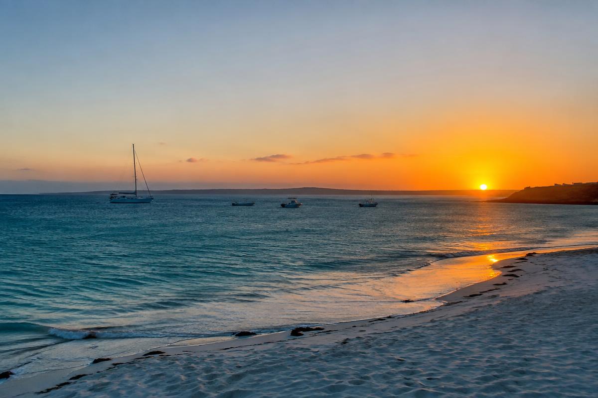 West Coast beach and moored boats at sunset